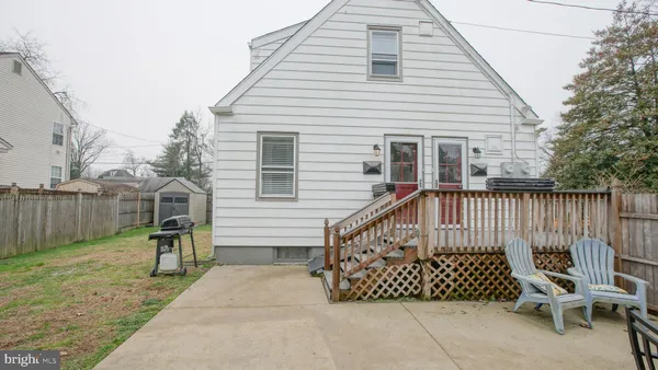 a view of a house with a yard and wooden fence