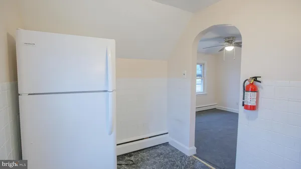 a view of storage and utility room with an empty room