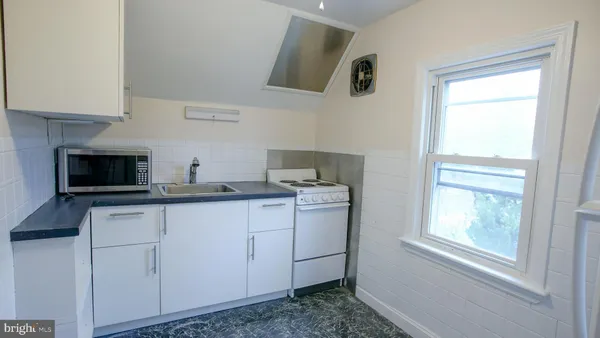 a kitchen with stainless steel appliances granite countertop a sink and a stove top oven