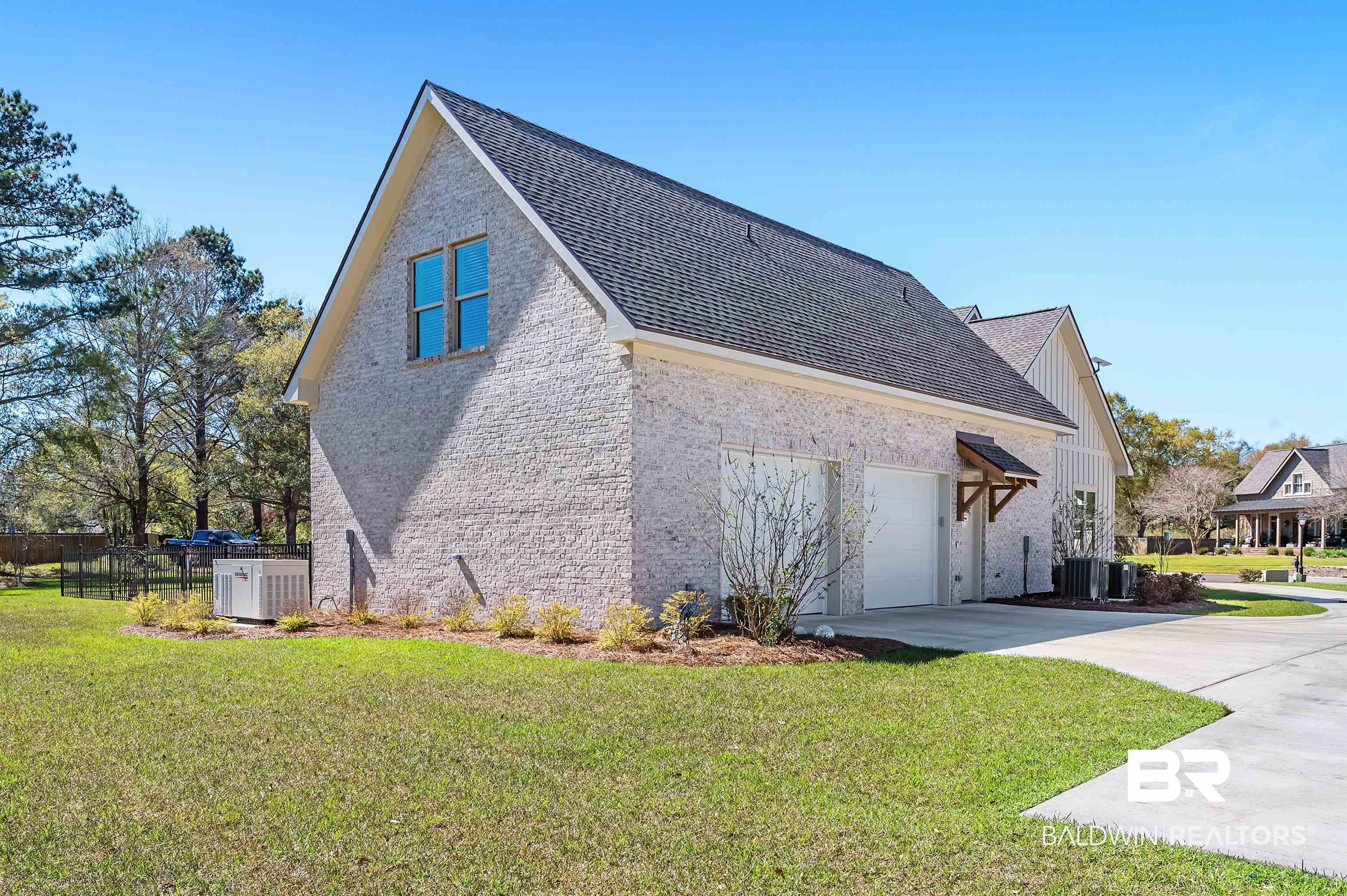 9144 Harvest Ridge Fairhope, AL 36532 - Photo 10 of 58 View of home's exterior with driveway, roof with shingles, an attached garage, fence, and a yard
