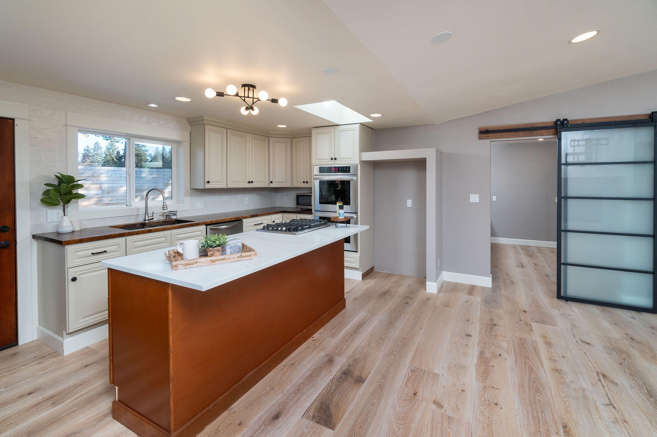 61151 Parrell Road Bend, OR 97702 - Photo 8 of 47 Functional kitchen with double ovens, new quartz island counter top and new sliding door to the pantry and laundry room.