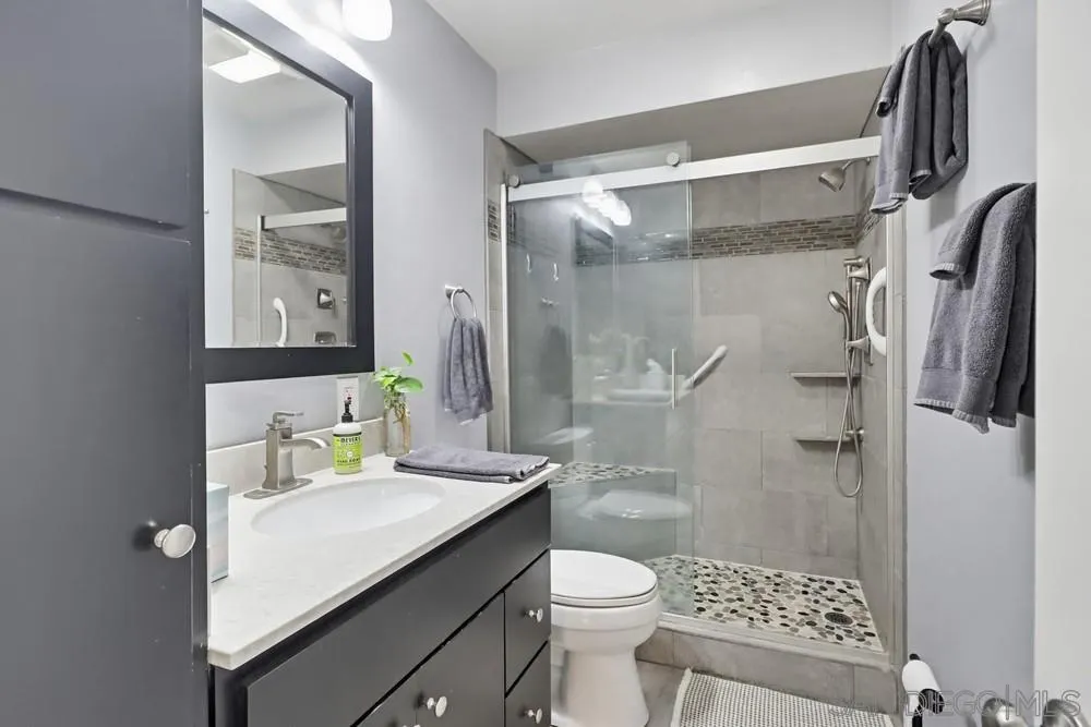 6416 Friars Road, Unit 111 San Diego, CA 92108 - Photo 11 of 21 a bathroom with a sink toilet and shower