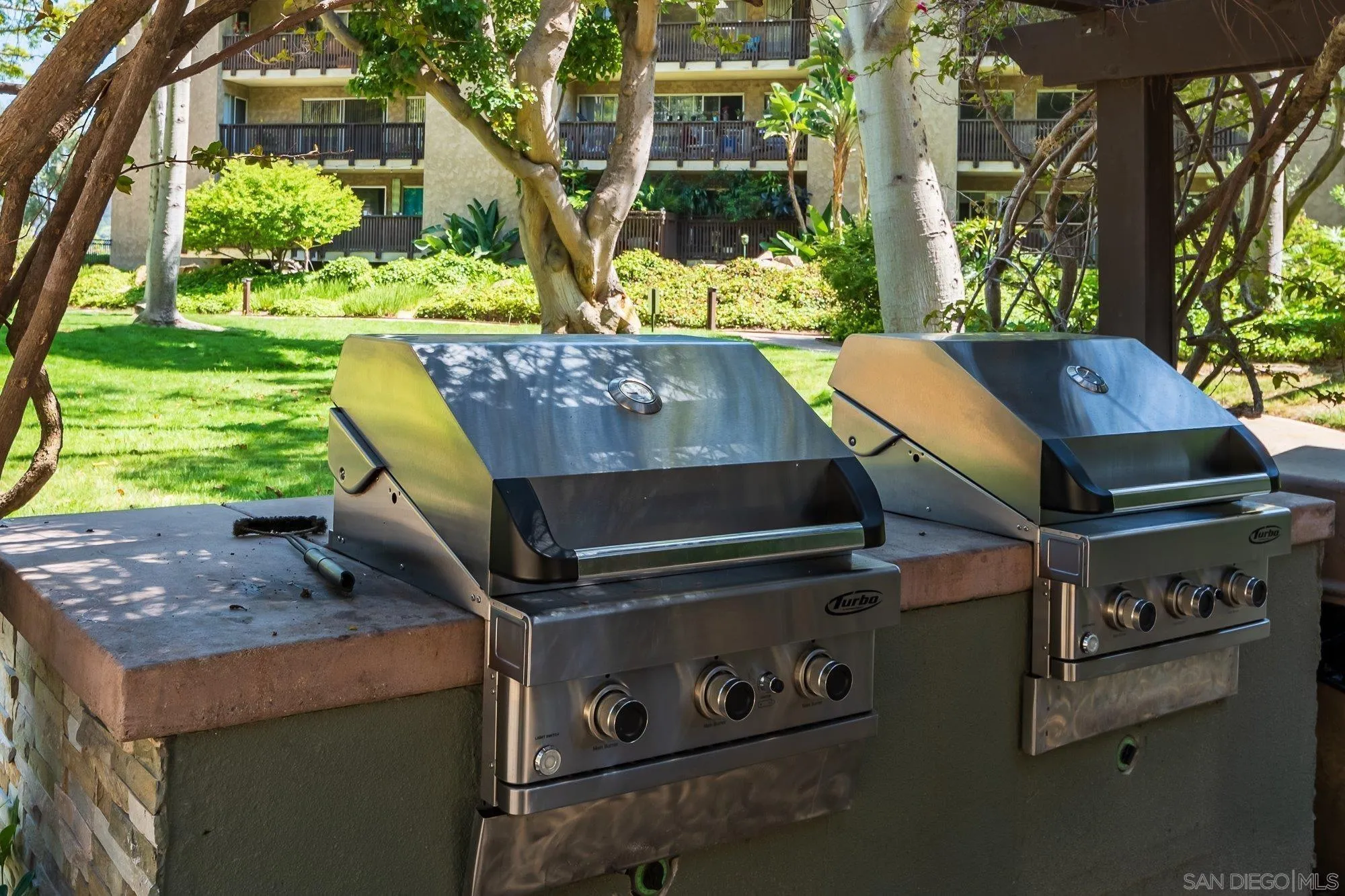 6416 Friars Road, Unit 111 San Diego, CA 92108 - Photo 18 of 21 a view of a backyard with table and chairs