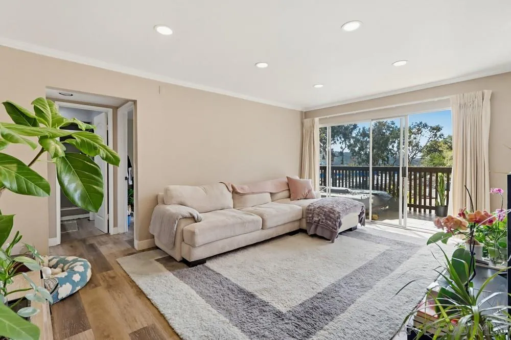 6416 Friars Road, Unit 111 San Diego, CA 92108 - Photo 2 of 21 a living room with furniture and a potted plant
