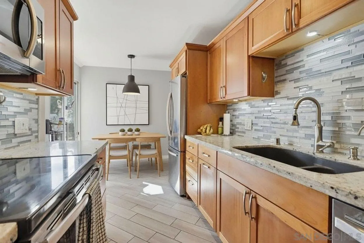 6416 Friars Road, Unit 111 San Diego, CA 92108 - Photo 5 of 21 a kitchen with stainless steel appliances a sink and a stove