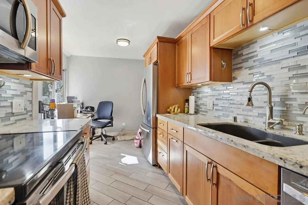 6416 Friars Road, Unit 111 San Diego, CA 92108 - Photo 6 of 21 a kitchen with stainless steel appliances a sink and a stove