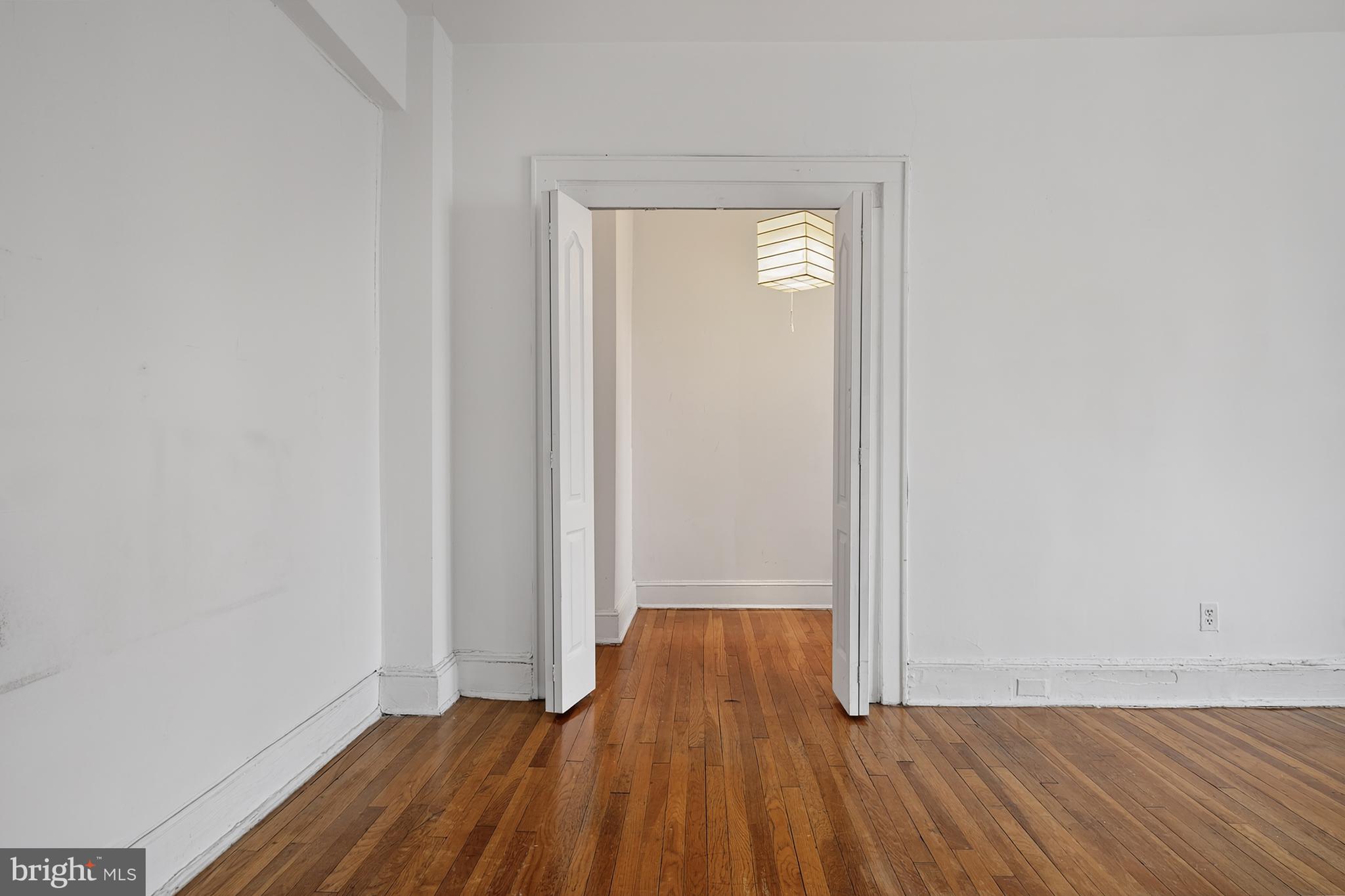 1820 Clydesdale Place Northwest, Unit 411 Washington, DC 20009 - Photo 14 of 33 a view of an empty room with wooden floor and a window