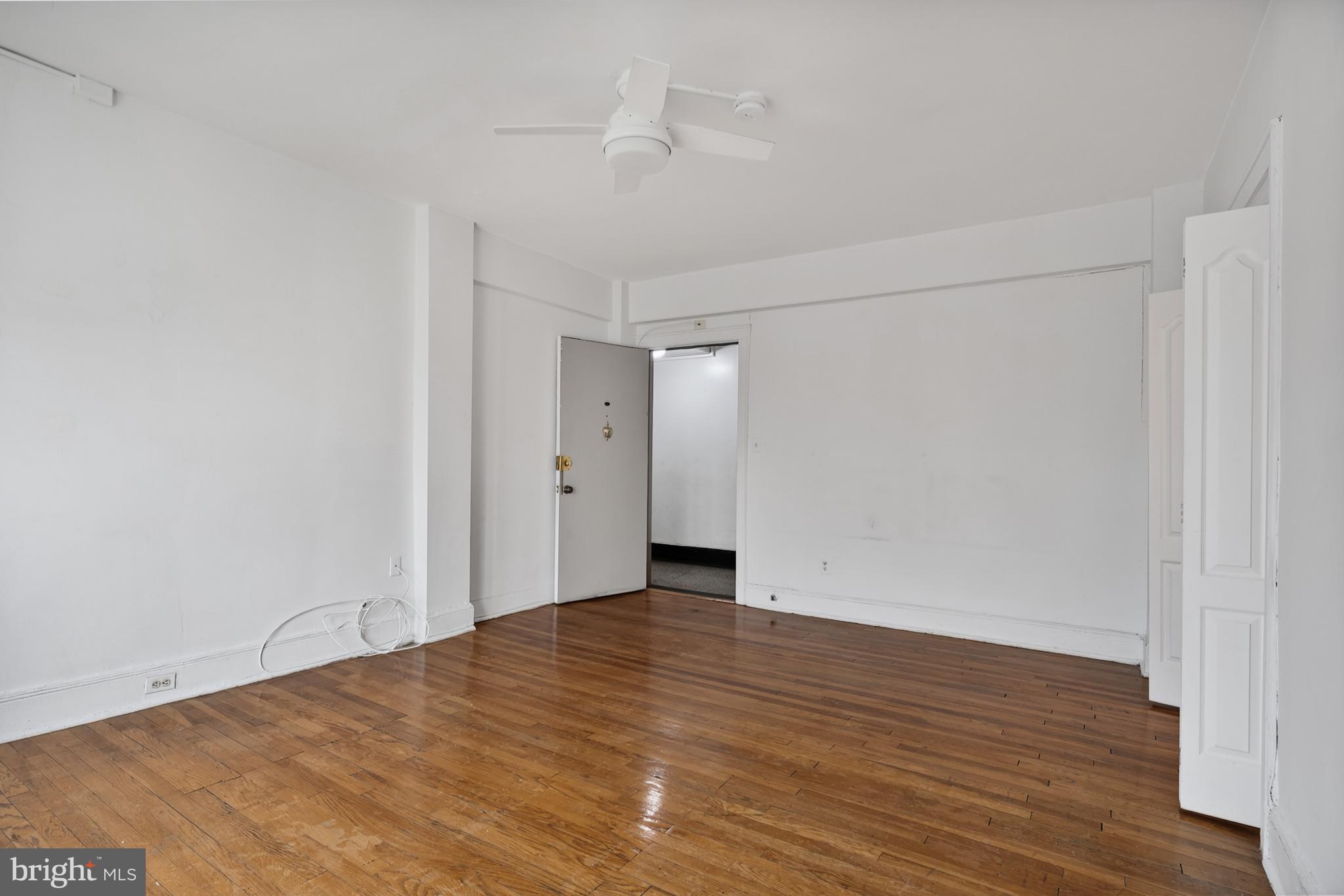 1820 Clydesdale Place Northwest, Unit 411 Washington, DC 20009 - Photo 5 of 33 a view of an empty room with wooden floor