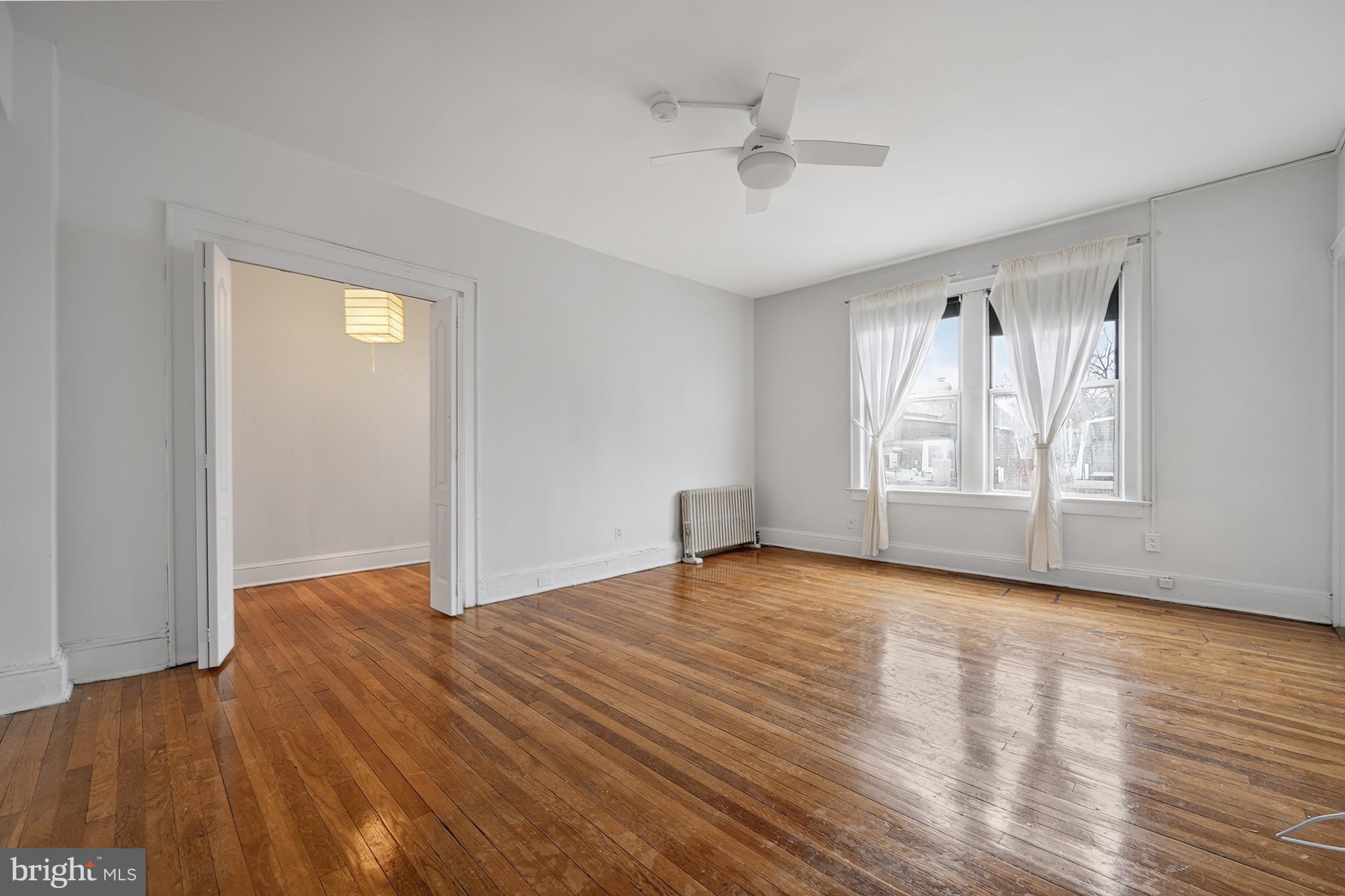 1820 Clydesdale Place Northwest, Unit 411 Washington, DC 20009 - Photo 6 of 33 a view of an empty room with wooden floor and a window
