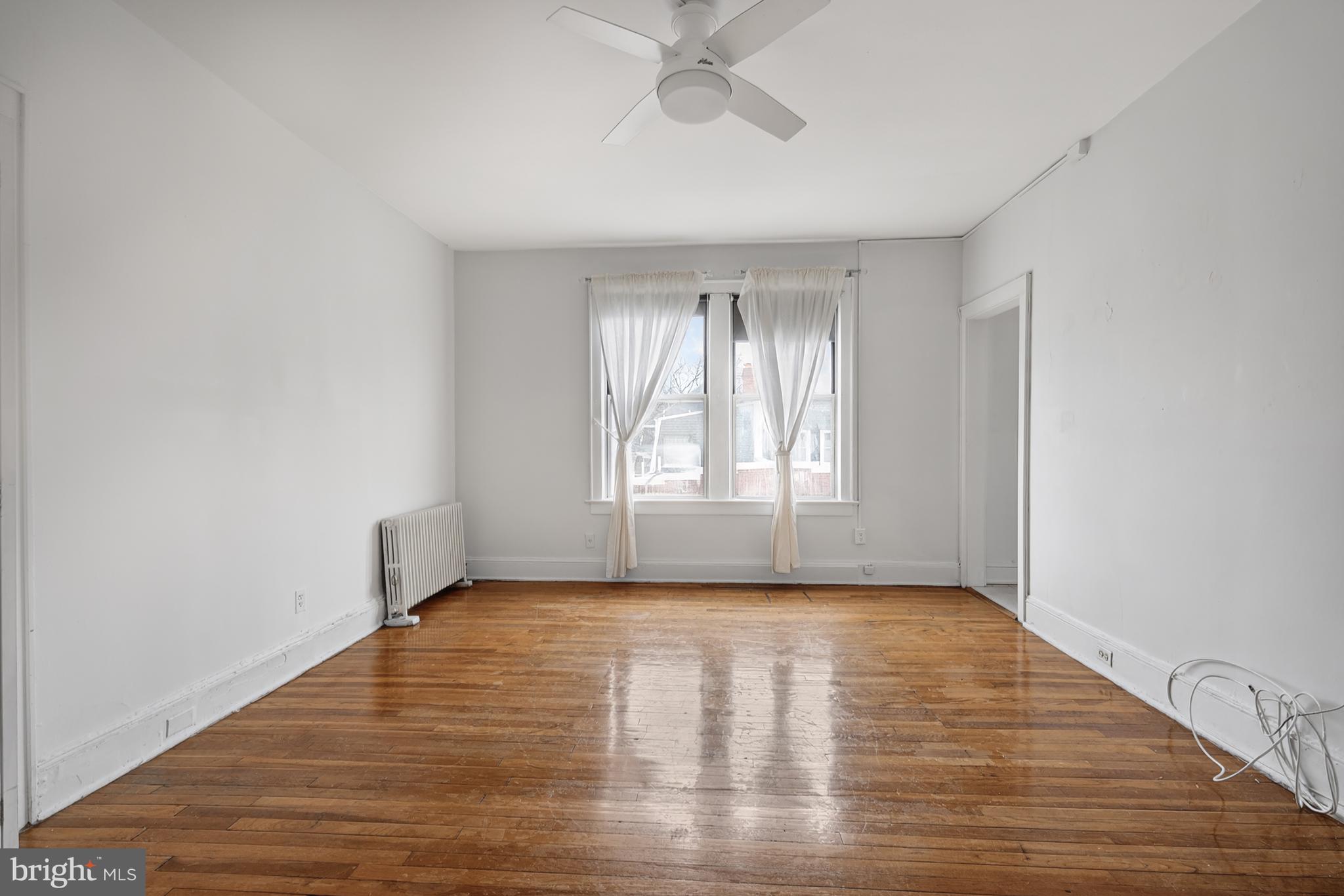 1820 Clydesdale Place Northwest, Unit 411 Washington, DC 20009 - Photo 7 of 33 a view of an empty room with wooden floor and window