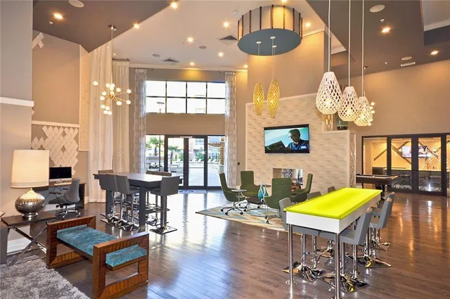 a living room with fireplace furniture and a chandelier