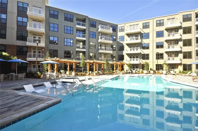 a view of a swimming pool with outdoor seating