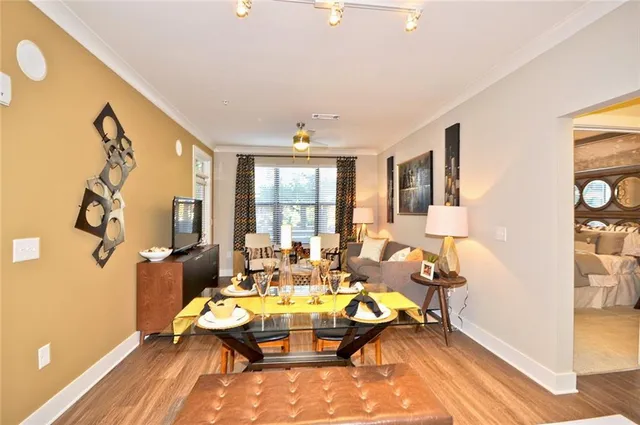 a dining room with furniture and wooden floor