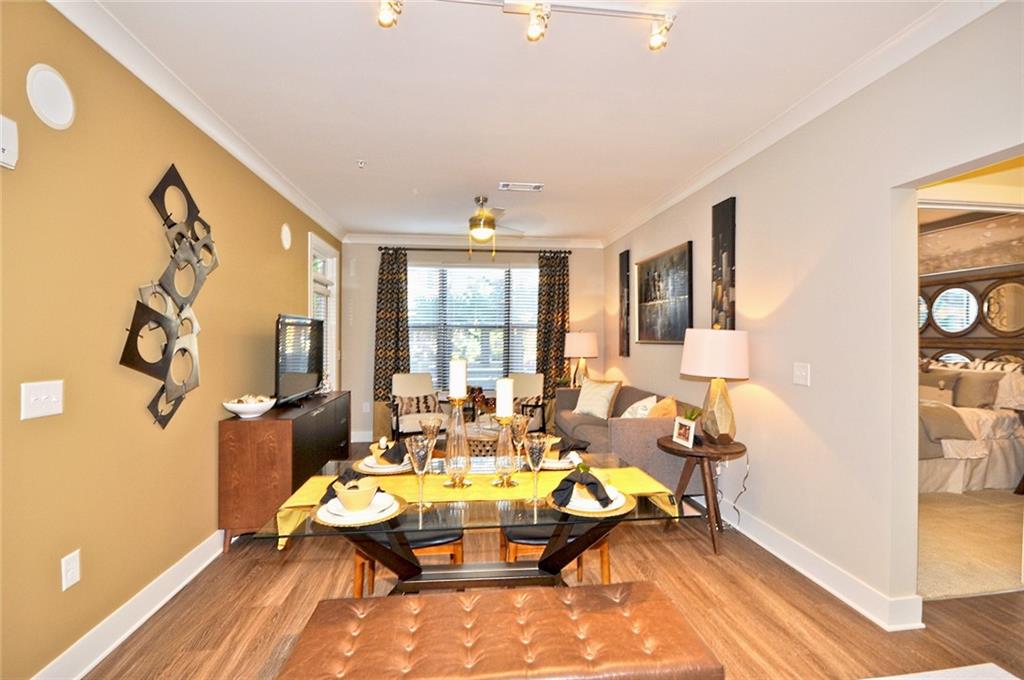 2875 Crescent Parkway, Unit 1117 Smyrna, GA 30080 - Photo 3 of 23 a dining room with furniture and wooden floor