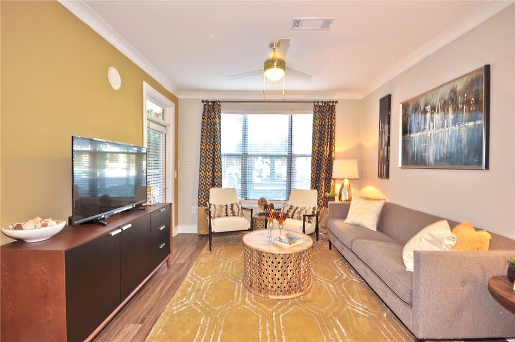 2875 Crescent Parkway, Unit 1117 Smyrna, GA 30080 - Photo 4 of 23 a living room with furniture and a flat screen tv