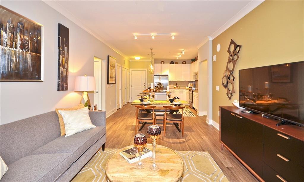 2875 Crescent Parkway, Unit 1117 Smyrna, GA 30080 - Photo 6 of 23 a living room with furniture and a flat screen tv