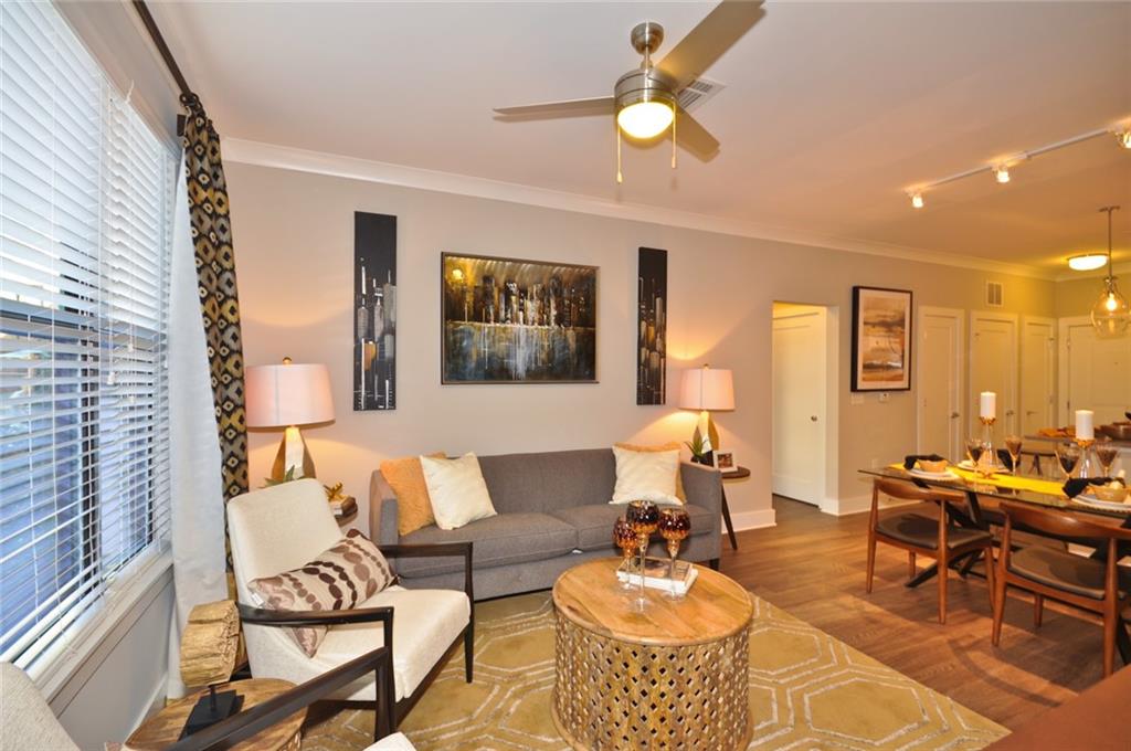 2875 Crescent Parkway, Unit 1117 Smyrna, GA 30080 - Photo 7 of 23 a living room with furniture and a large window