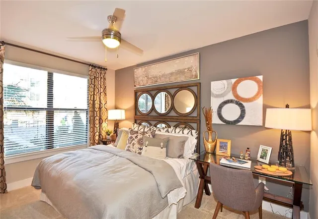 a bedroom with a bed and a large window