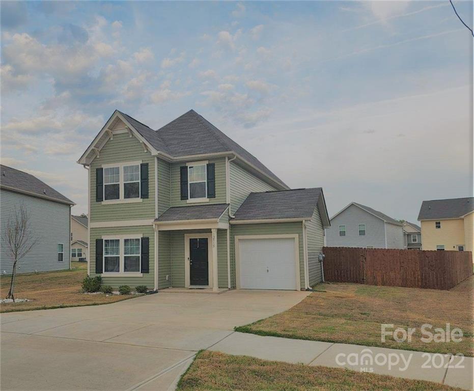 12515 Gotland Road Midland, NC 28107 - Photo 2 of 2 a front view of a house with a yard and garage