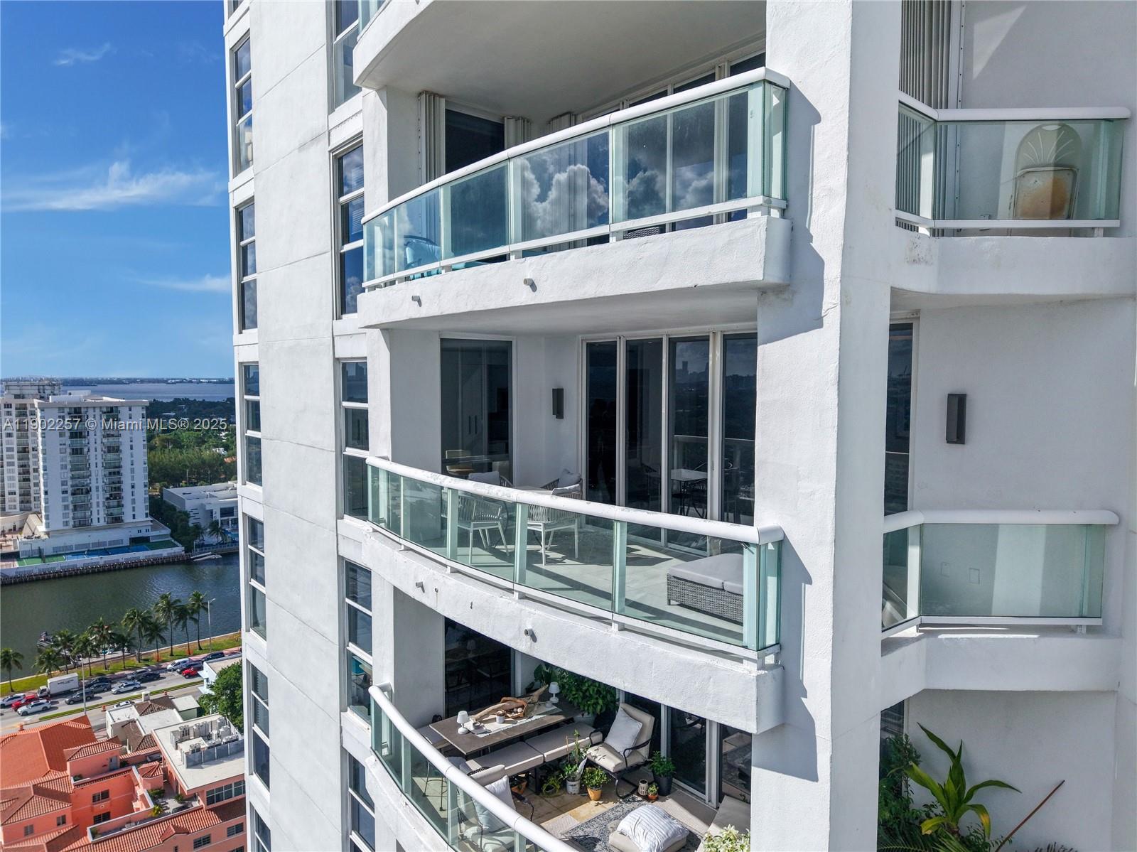 4201 Collins Avenue, Unit 2101 Miami Beach, FL 33140 - Photo 44 of 50 a balcony with table and chairs