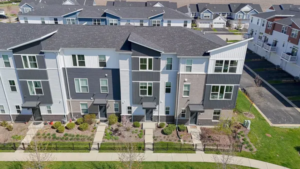 a front view of a residential apartment building with a yard