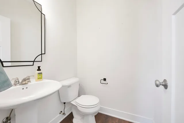 a bathroom with a sink a toilet and a mirror