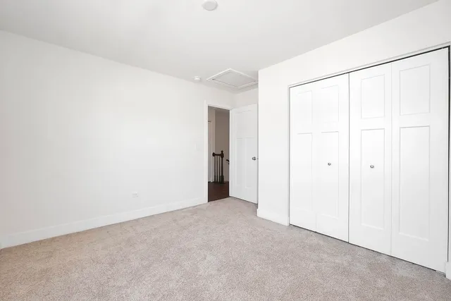 a bedroom with a bed and a potted plant