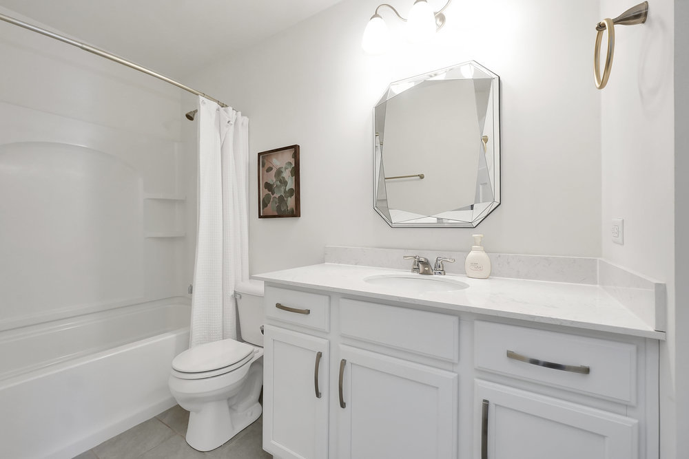 4133 Calder Lane Aurora, IL 60504 - Photo 15 of 38 a bathroom with a toilet sink vanity tub and shower