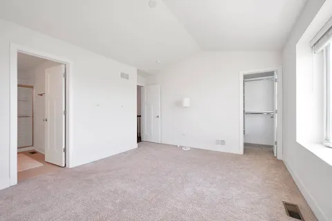 a view of walk in closet with empty racks