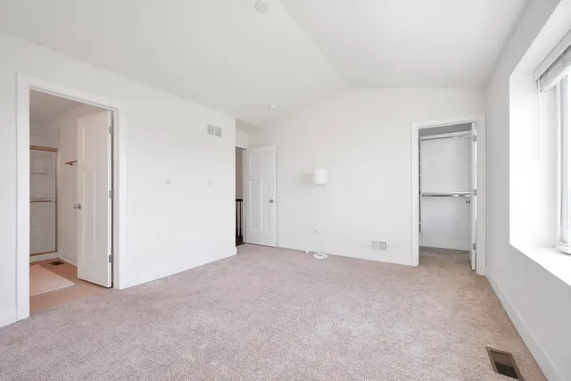 a view of walk in closet with empty racks