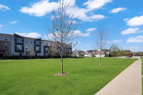 a front view of multiple houses with yard