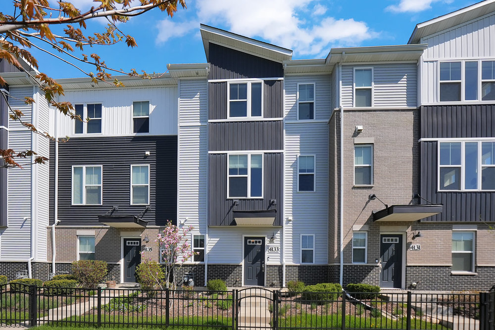 4133 Calder Lane Aurora, IL 60504 - Photo 26 of 38 front view of a brick house with a large windows