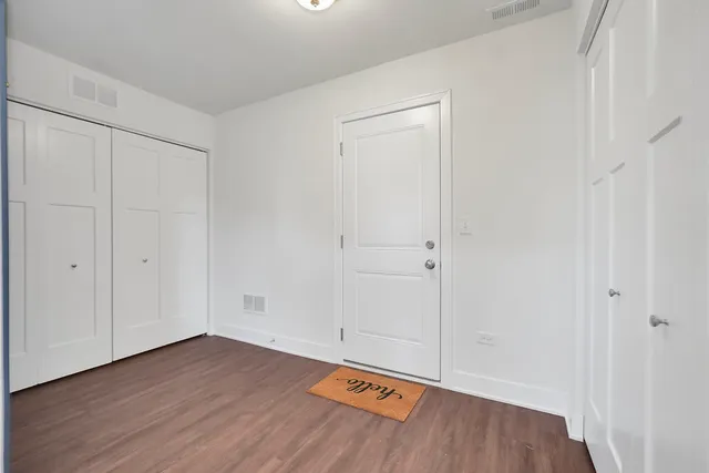 a view of a room with wooden floor