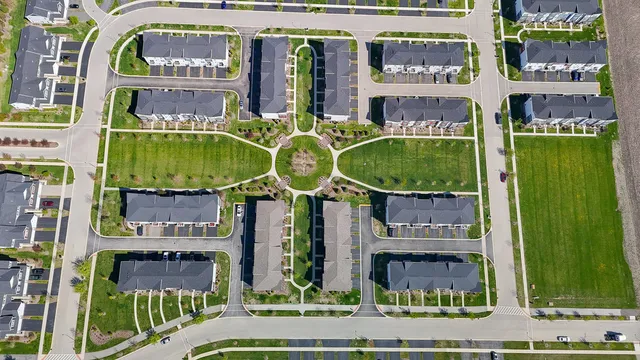 an aerial view of a house with swimming pool outdoor seating and mountain view