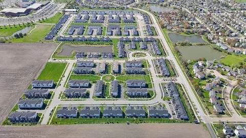 a aerial view of multiple houses with yard