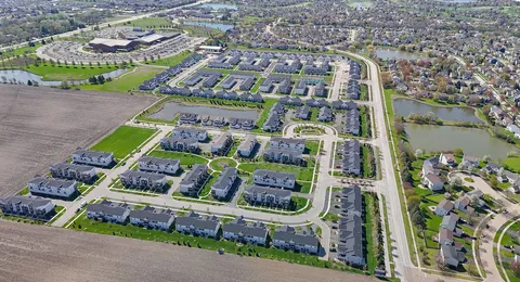 a front view of multiple houses with yard