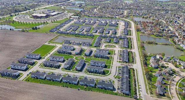 a front view of multiple houses with yard