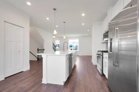 a kitchen with a sink and refrigerator