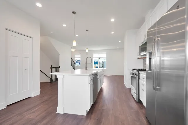 a kitchen with a sink and refrigerator