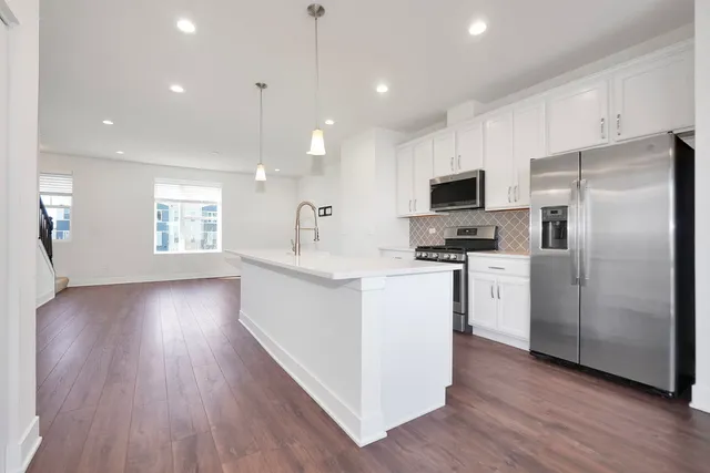 a kitchen with refrigerator and microwave
