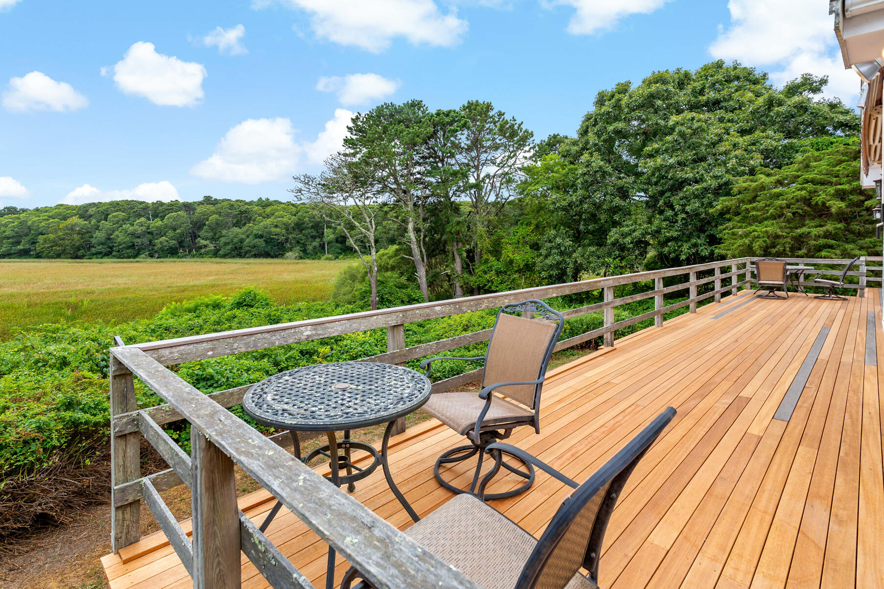 107 Abbey Gate Road Cotuit, MA 02635 - Photo 3 of 22 a view of a chairs and table on the terrace
