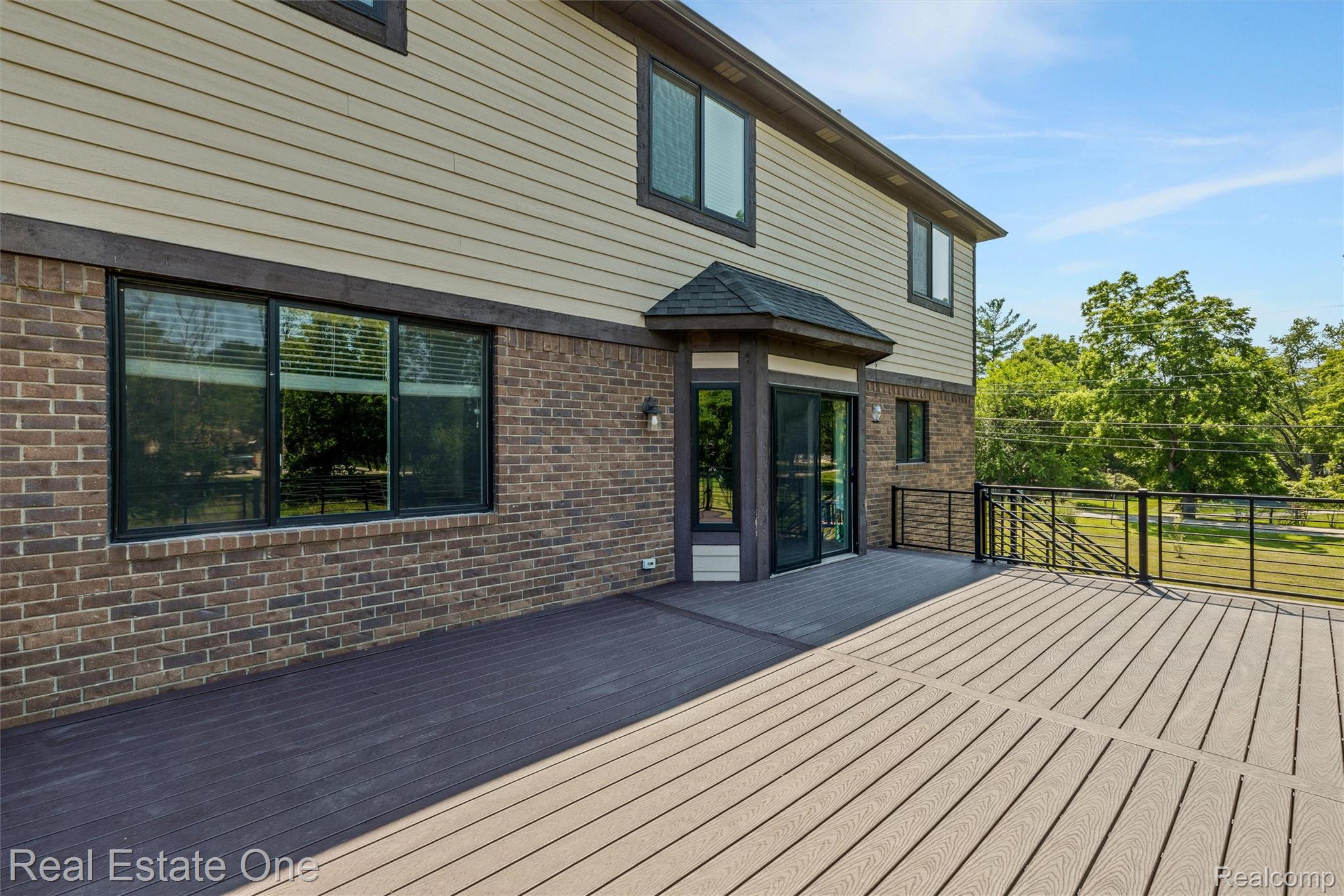 2983 28 Mile Road Washington, MI 48094 - Photo 50 of 54 Multi-tone composite decking featuring a black metal railing system