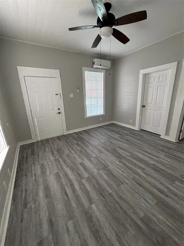 a view of an empty room and wooden floor