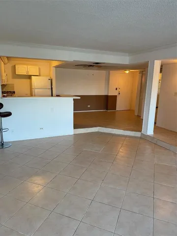 a view of a room with wooden floor and white walls