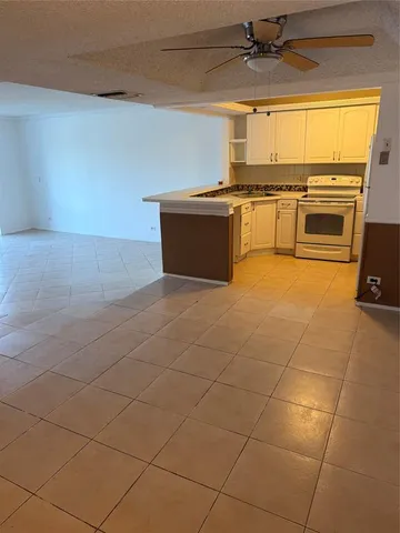 a kitchen with stainless steel appliances a stove a sink and a refrigerator