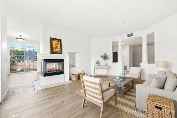 a living room with furniture and a fireplace