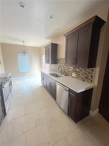 a kitchen with a stove top oven and cabinets