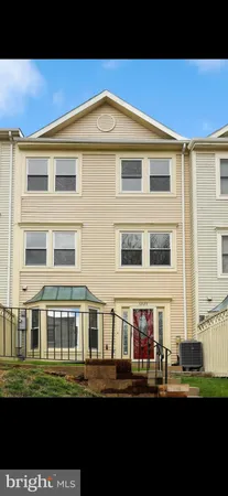 a front view of a building with a garden