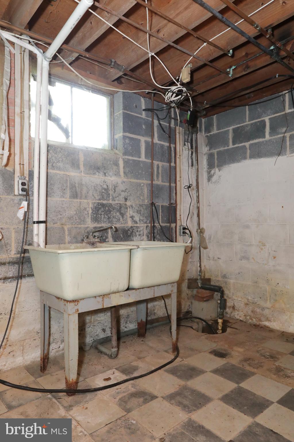 10901 Cross Rd Trail Brandywine, MD 20613 - Photo 40 of 50 Utility sink and sump pump in basement