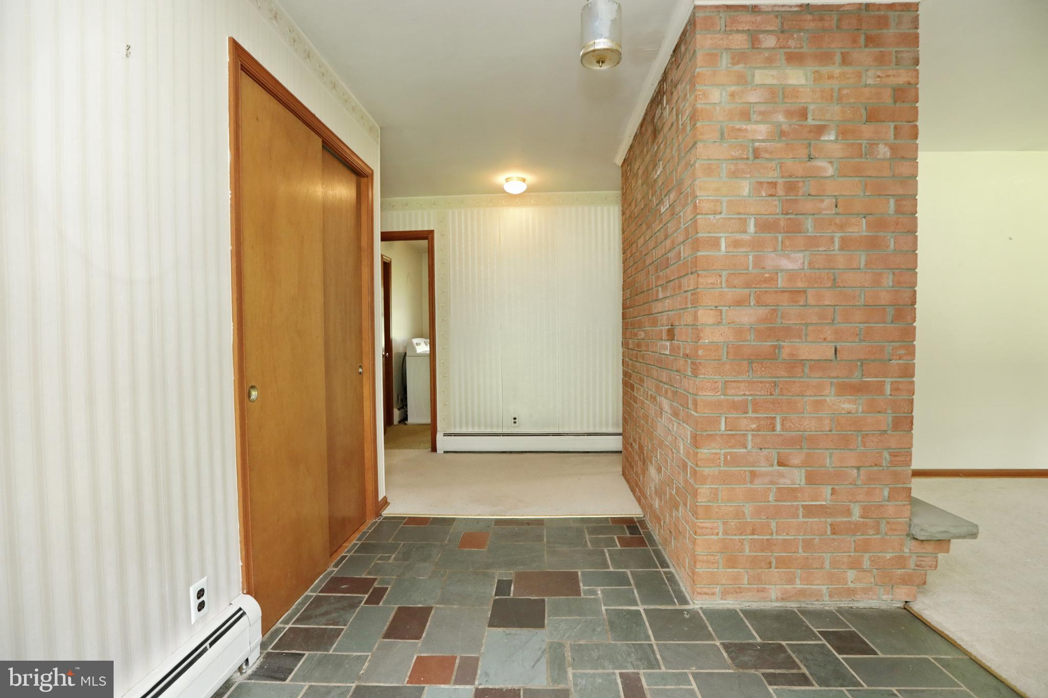 10901 Cross Rd Trail Brandywine, MD 20613 - Photo 6 of 50 Foyer with tile and exposed brick Fireplace